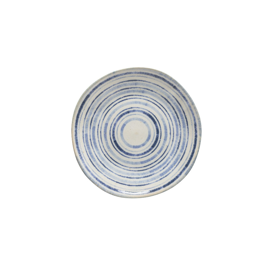 A ceramic salad plate with a blue and white geometric pattern on a white background.