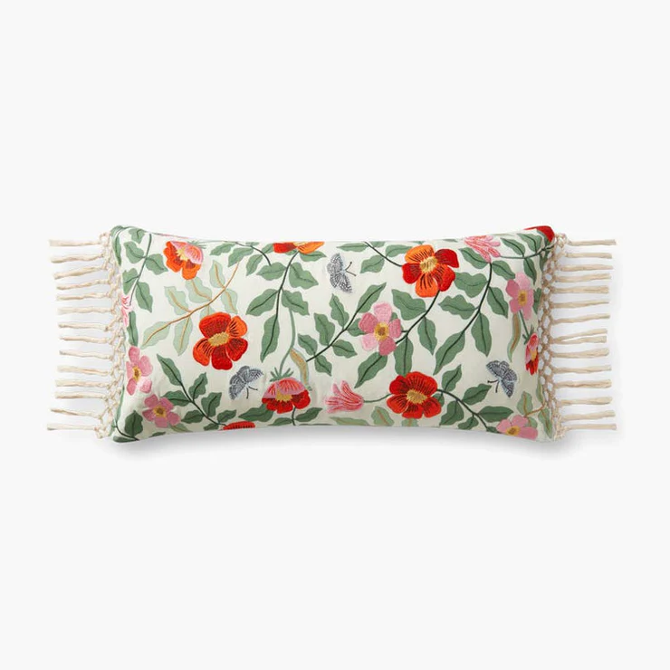 This image features the "Primrose Ivory Pillow," a decorative pillow with a charming floral pattern. The pillow displays a variety of colorful flowers and green foliage, creating a vibrant and inviting appearance.