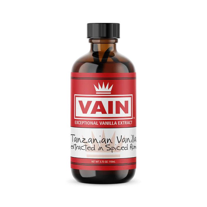 A bottle of VAIN brand Tanzanian Vanilla Extract with a label indicating it is an extract of Madagascar vanilla.