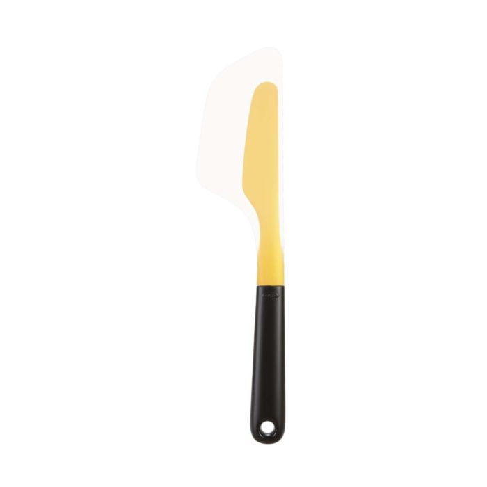 An OXO Flip & Fold Omelet Turner with a yellow and white plastic blade and a black handle.