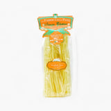 Package of La Fabbrica della Pasta gluten-free penne pasta on a white background