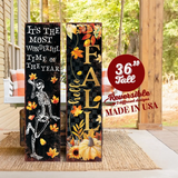 A 36-inch tall Halloween porch sign featuring fall-themed designs with text and decorative elements displayed on a wooden surface.