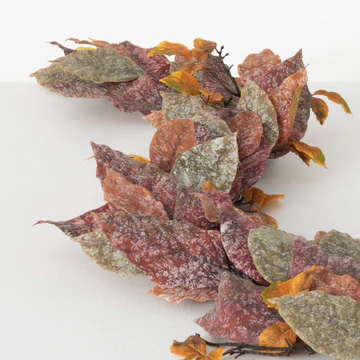 A decorative garland featuring a mix of leaves in shades of brown, red, and green.