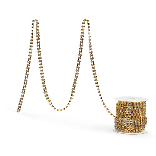 A gold rhinestone garland unrolled and displayed next to its packaging.
