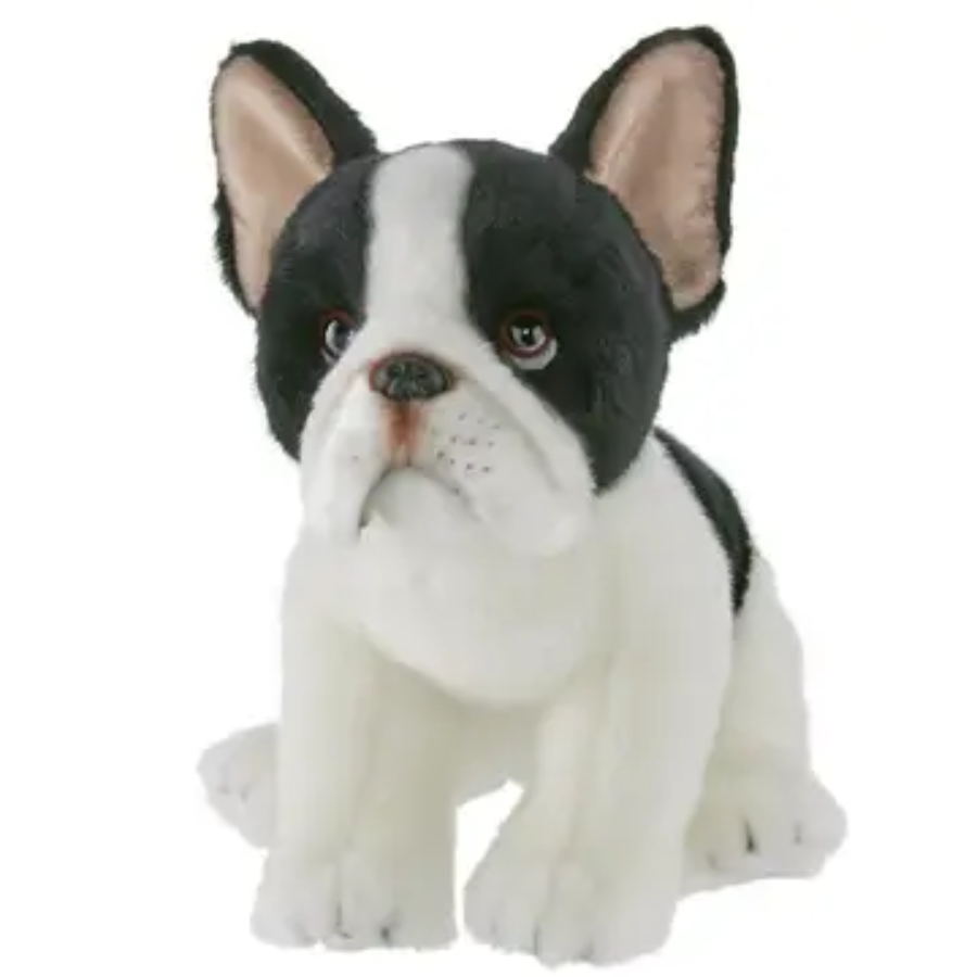 A plush toy resembling a small dog mainly white with black markings on a white back ground. 