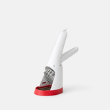 A white strawberry slicer with a red accent and a serrated wheel.